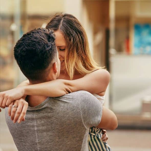 A man and woman kissing.