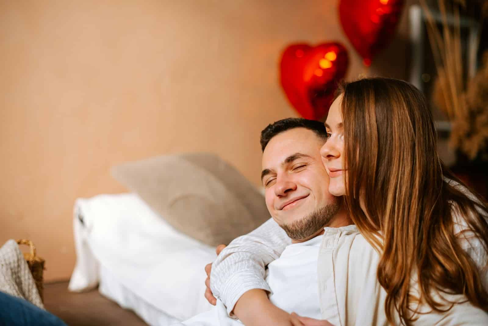 A man and woman hugging.