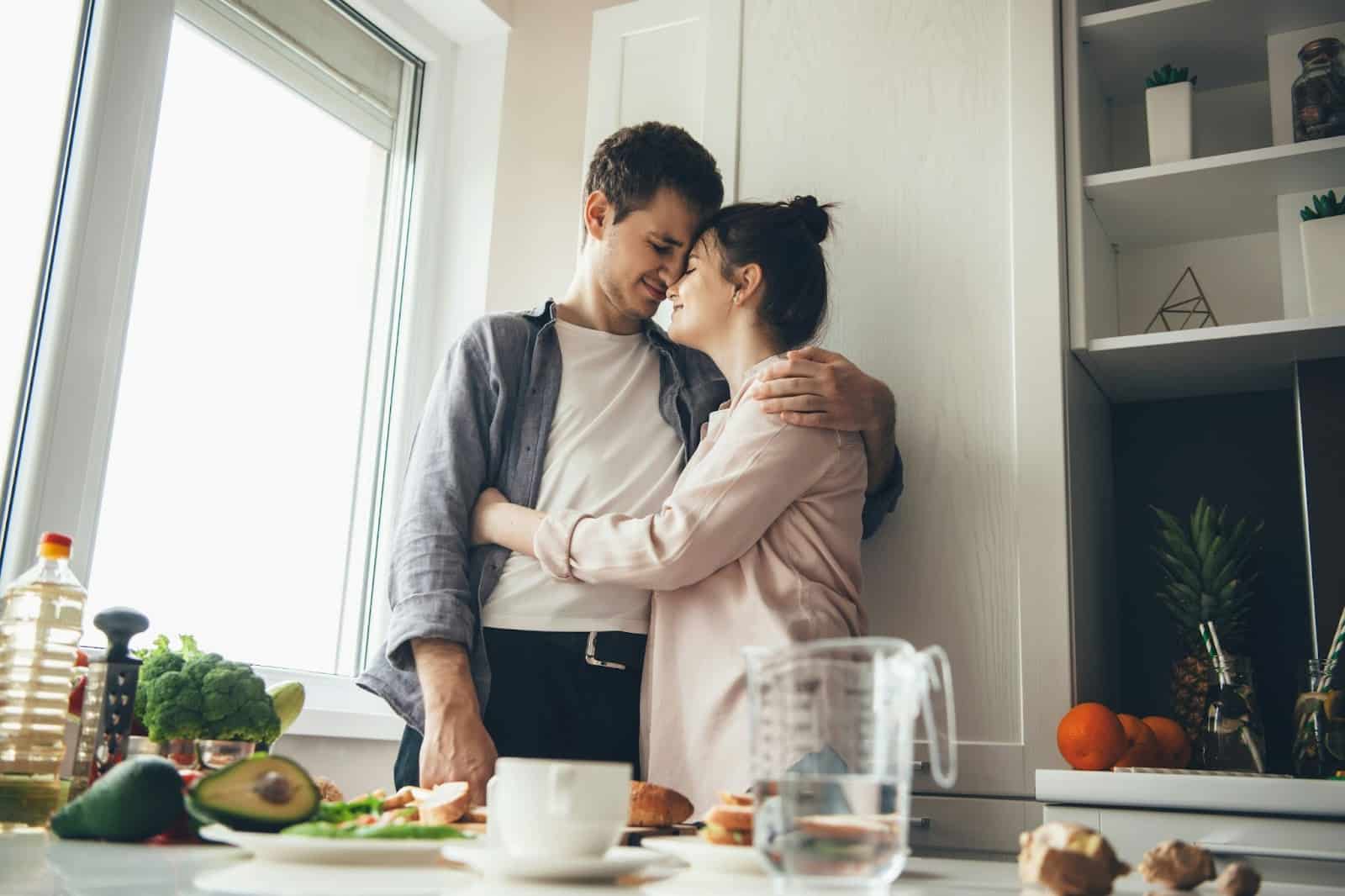 A man and woman hugging each other.