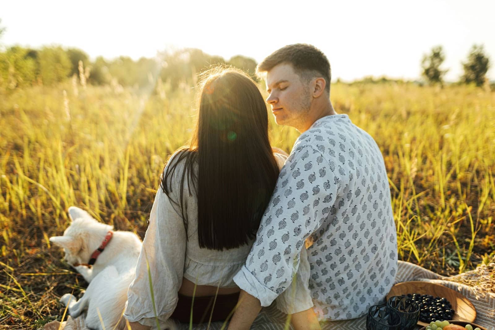 A man and woman at the field of grass.