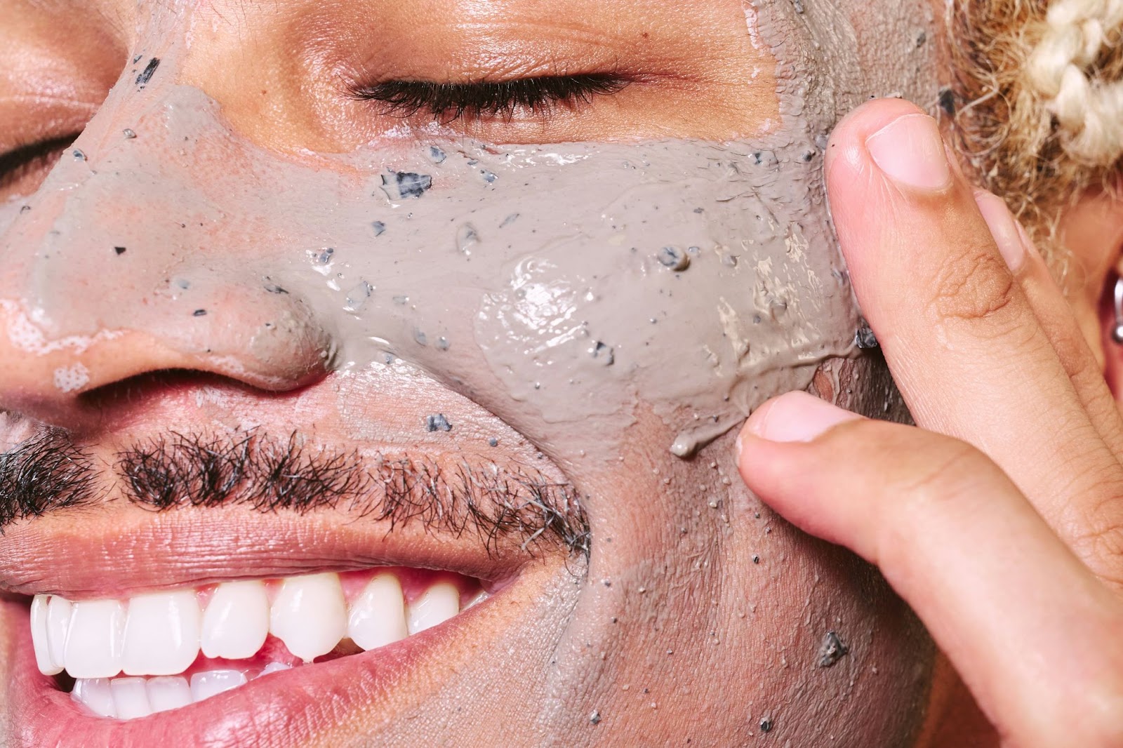 A man exfoliating face.