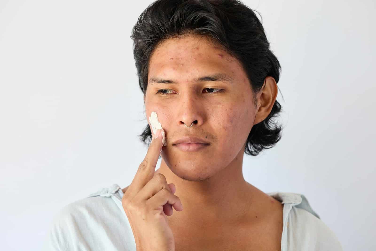 A man moisturizing face