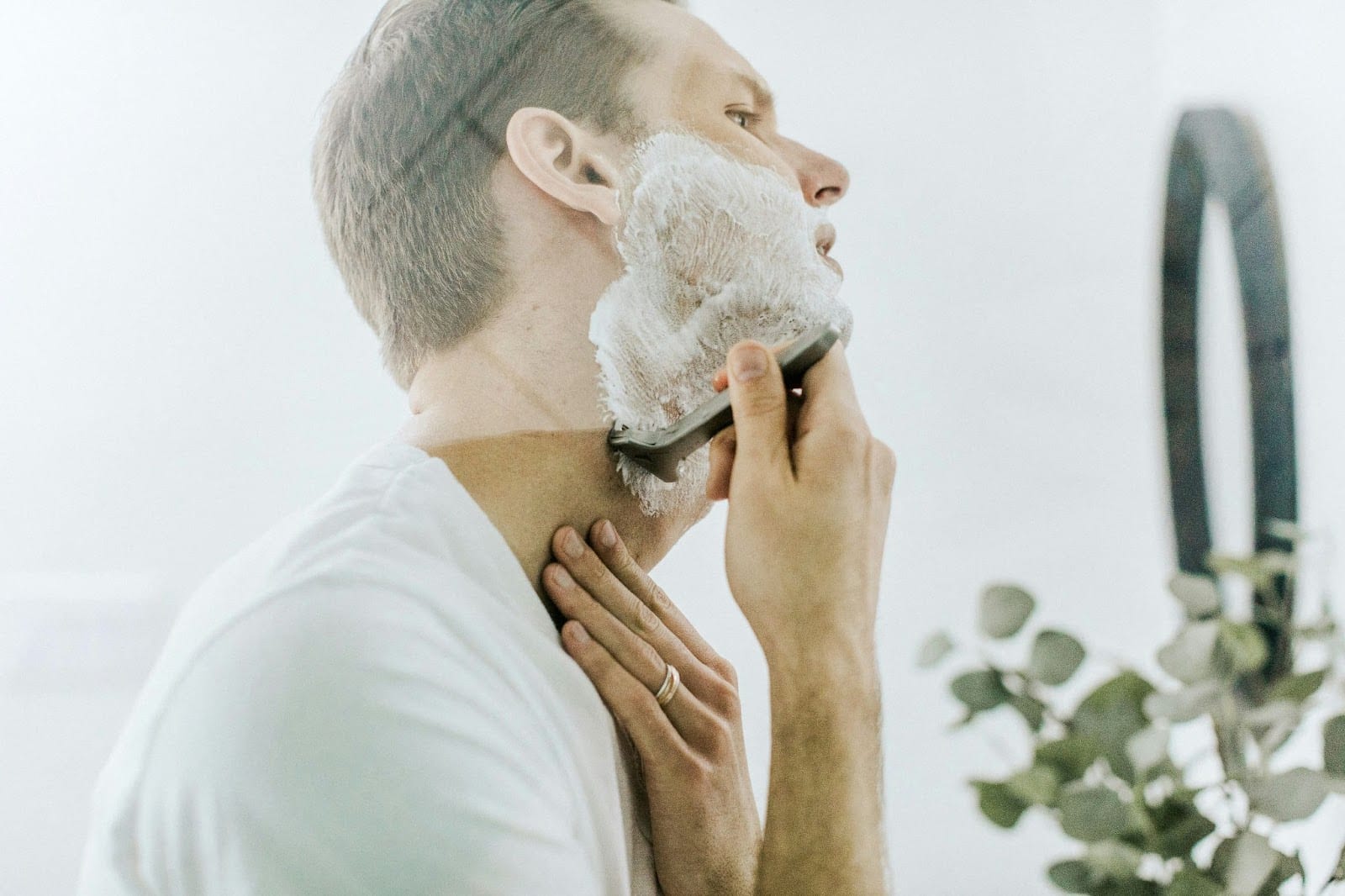 A picture of a man shaving.