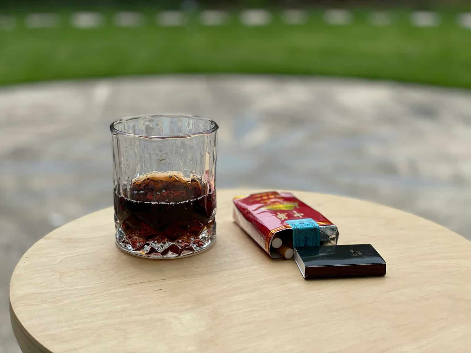 A picture of a cigarette and an alcohol.