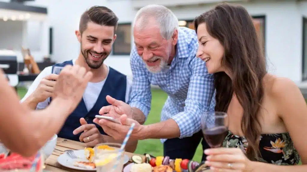 Man enjoying his time with the friends and family of his partner.