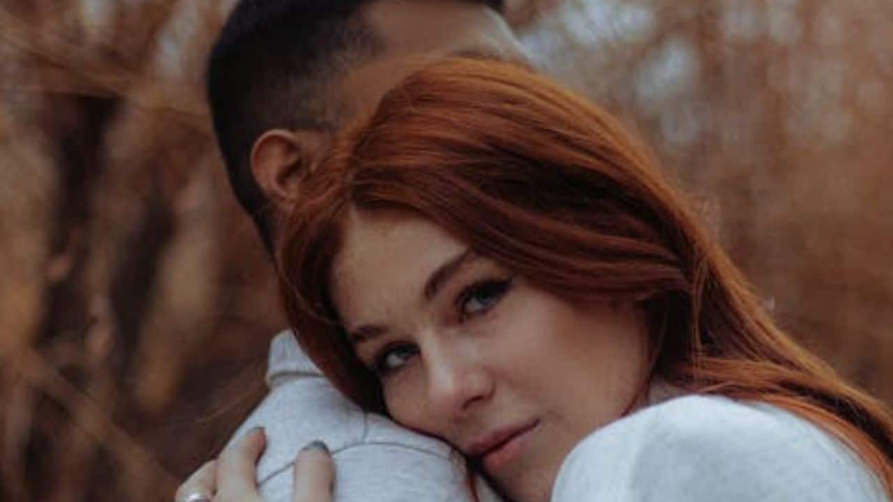 Woman embracing a man.