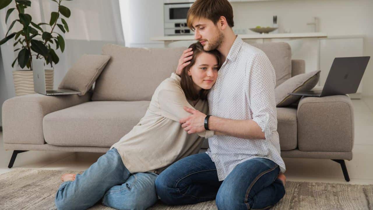 Couple hugging in the living room.