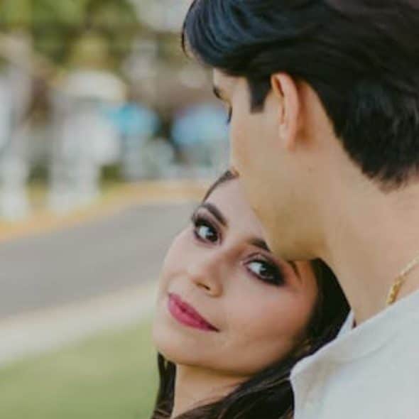 Woman leaning on a person in white long sleeve.