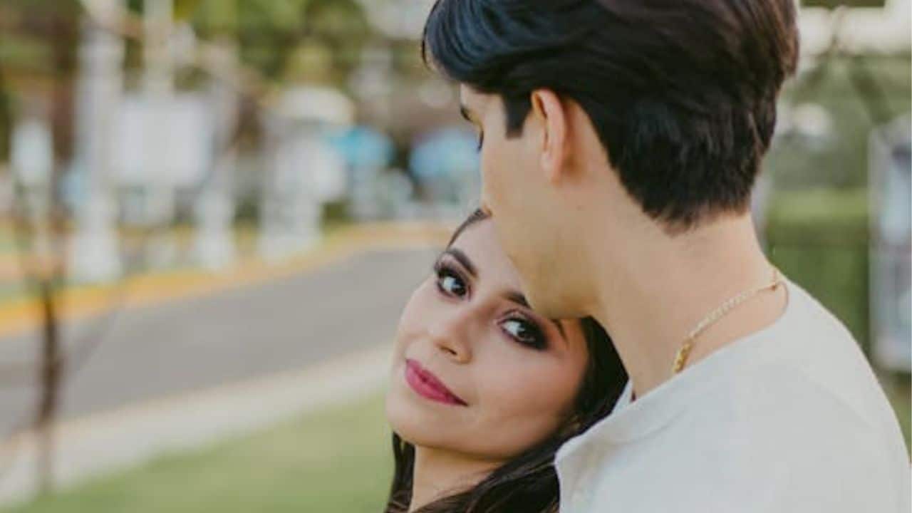 Woman leaning on a person in white long sleeve.