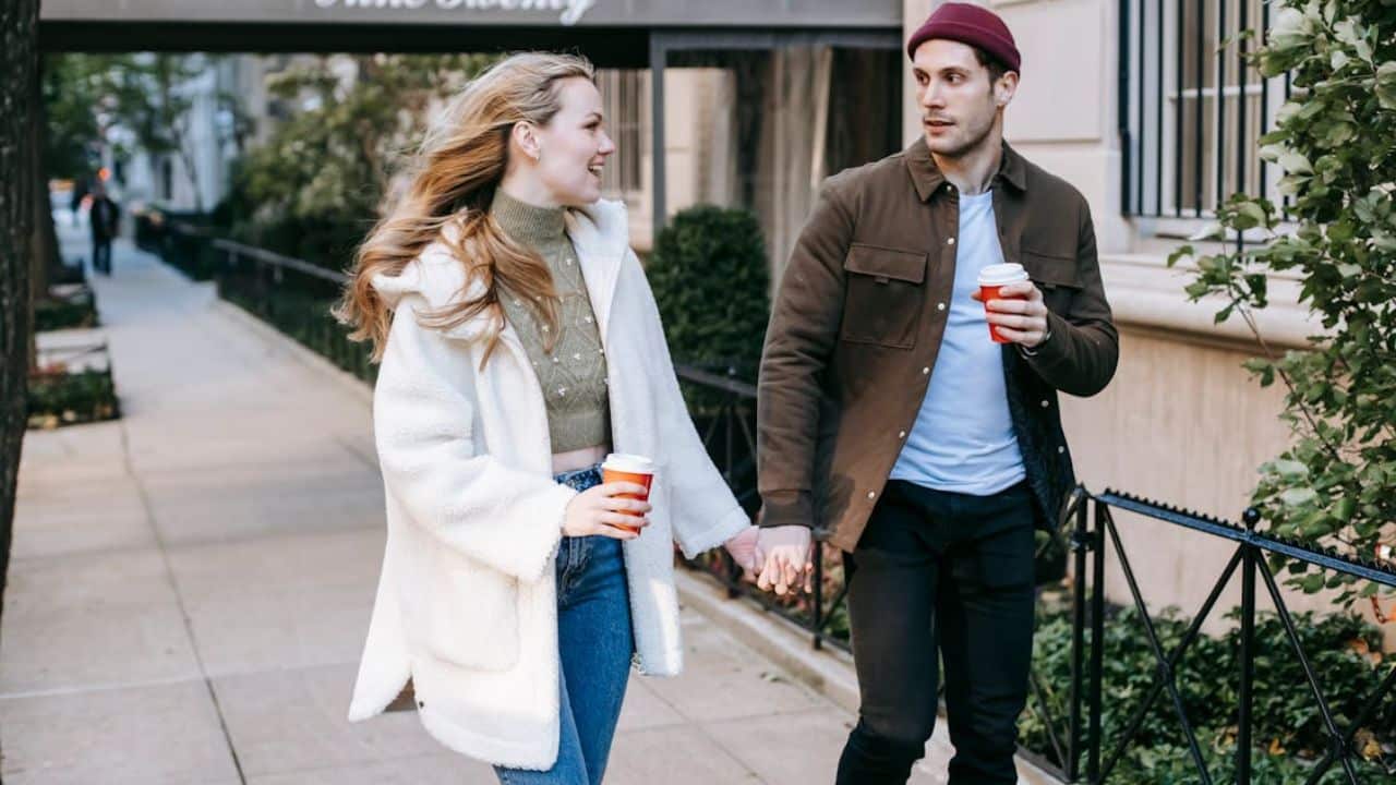 Happy young couple walking on the street.