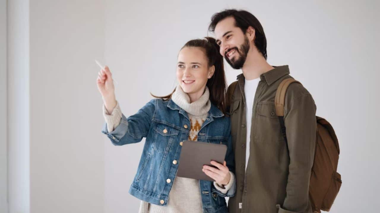 Young couple with tablet planning in a new flat.