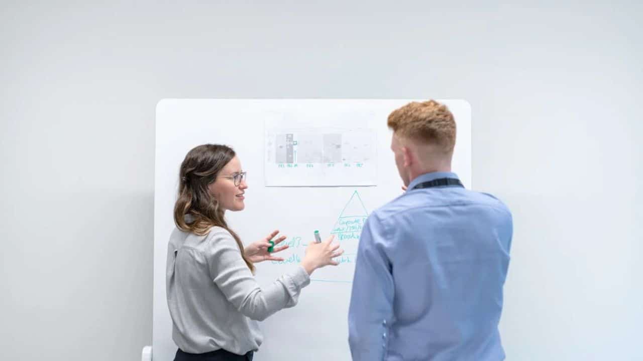 Woman encouraging man before a presentation or project.