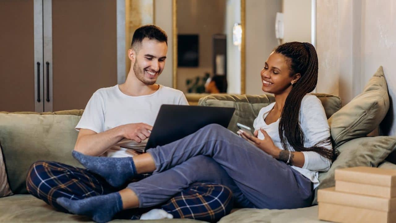 Couple enjoying a moment of laughter and friendship at home.