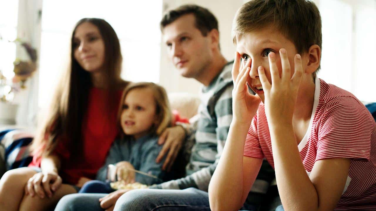 A family watching TV together.