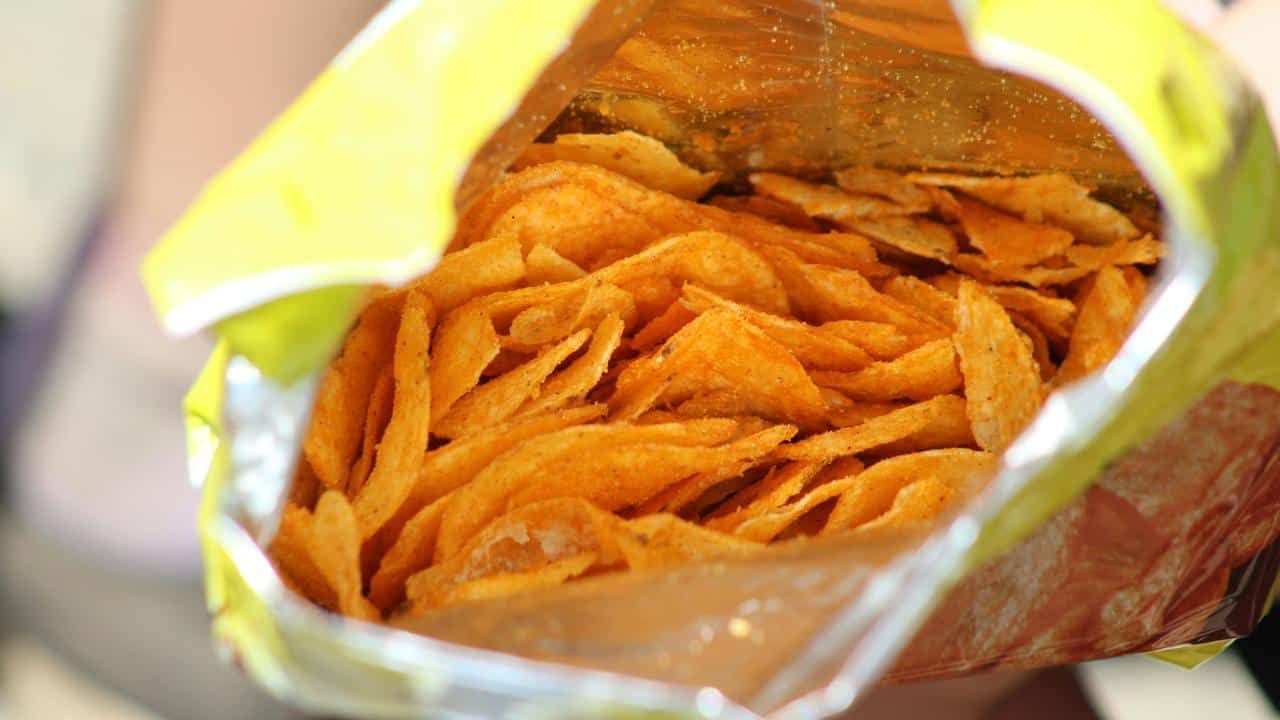 An open bag of seasoned potato chips.