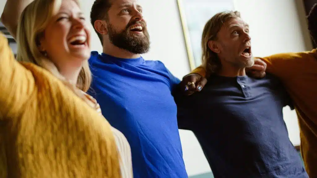 A group of friends cheering together with excitement.
