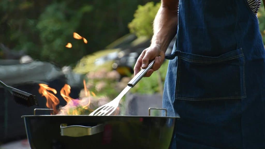 A person grilling over open flames.