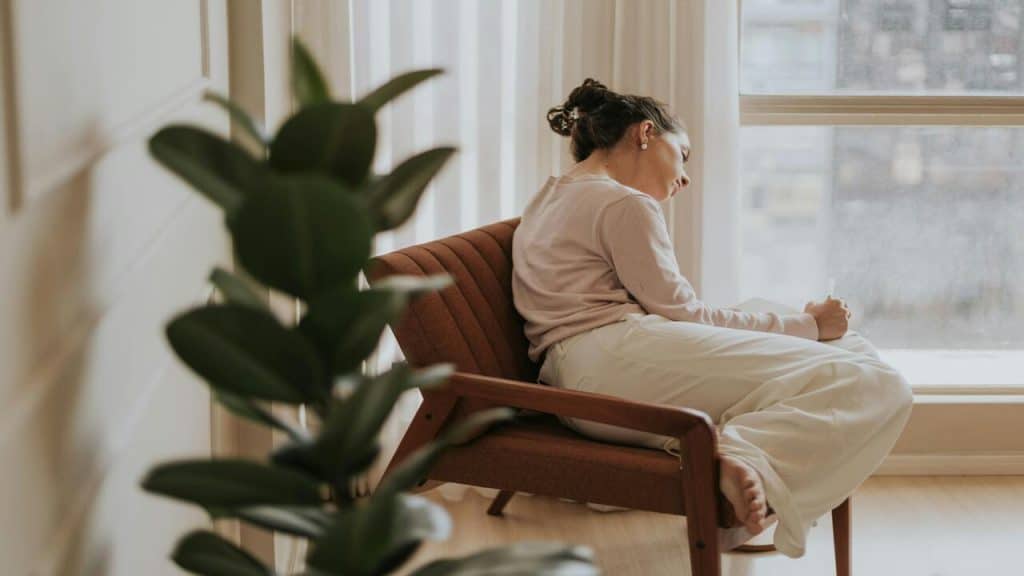 A woman looking sad at home.