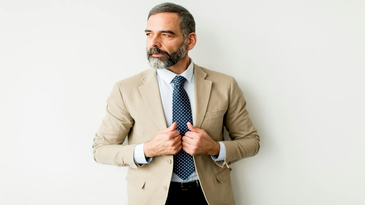 A handsome mature man deep in thought.