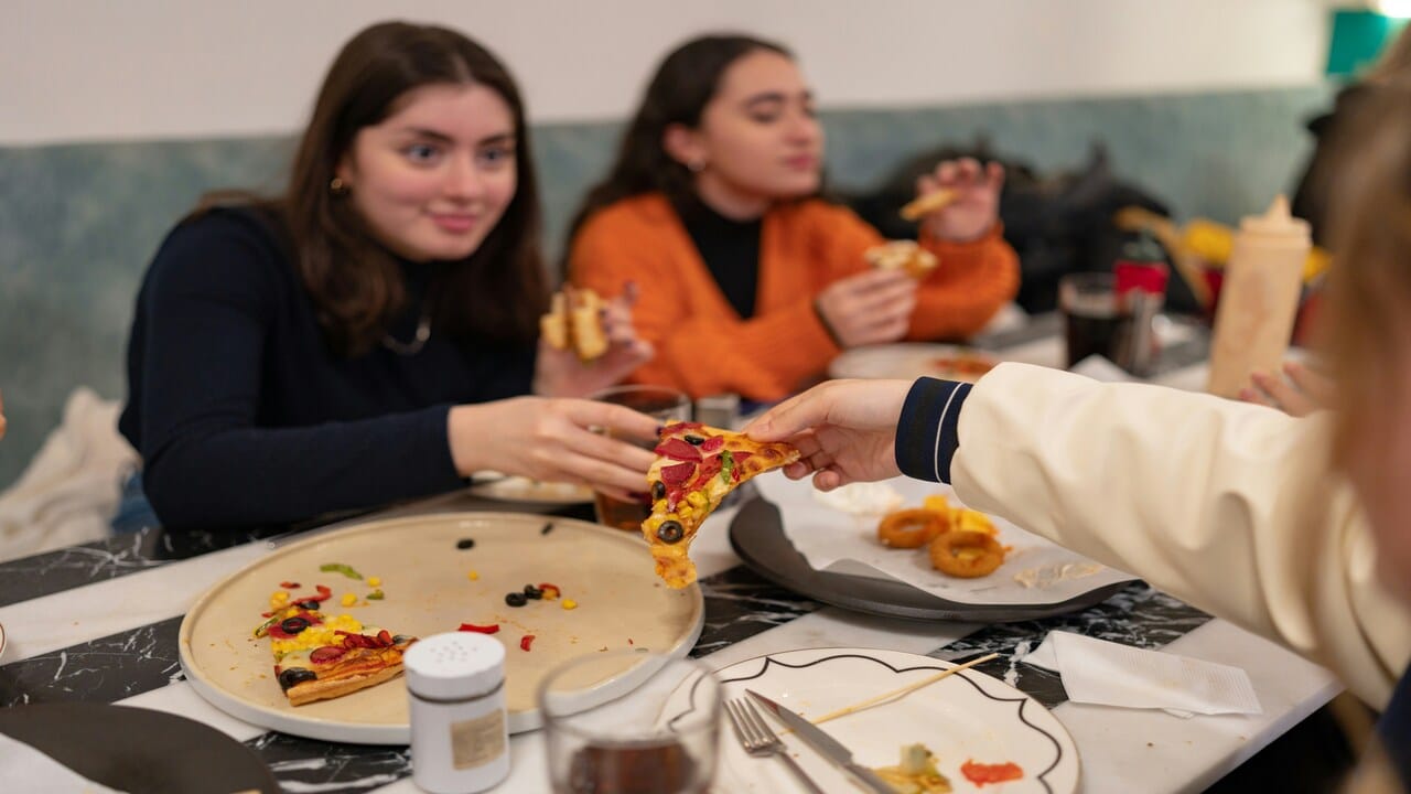 Friends having pizza together.