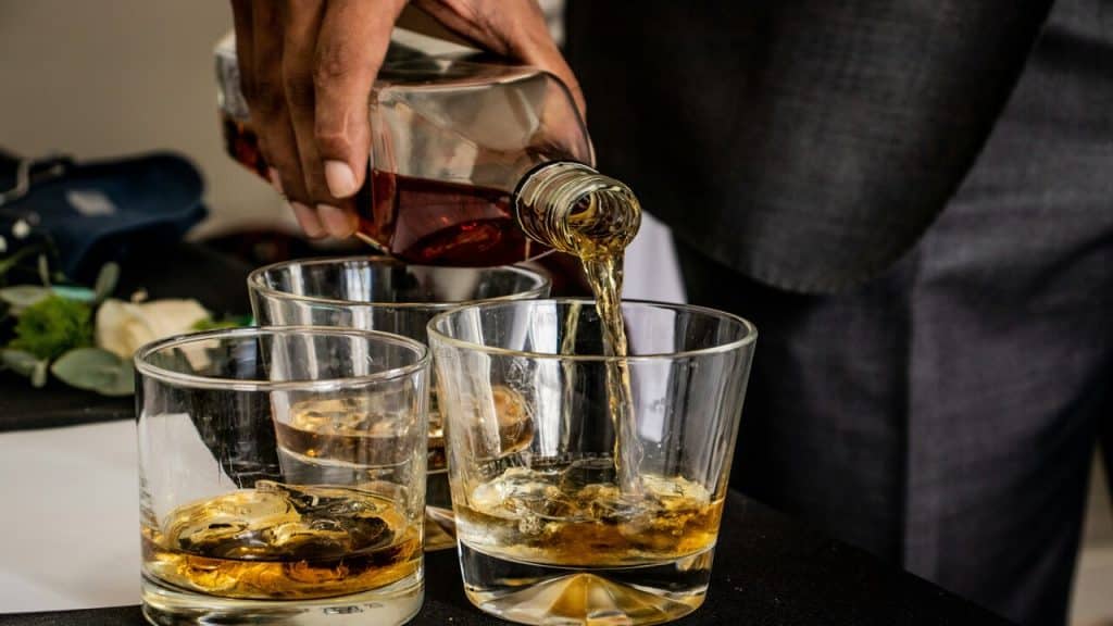 A man getting ready to drink whiskey