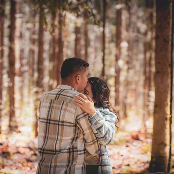 A man kissing a woman’s forehead
