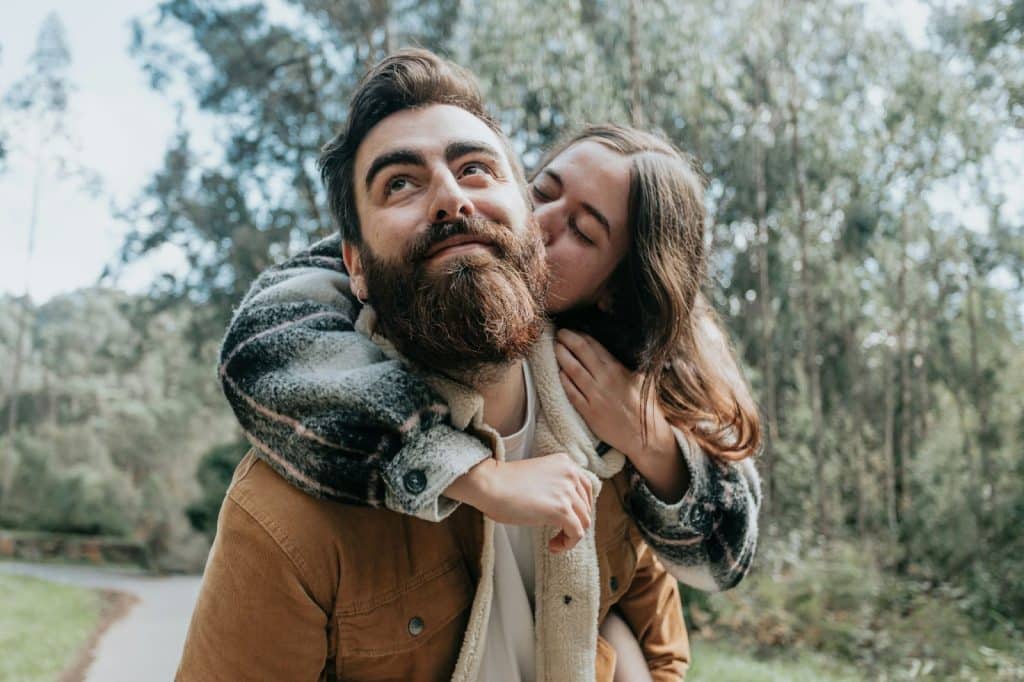 A woman kissing a man