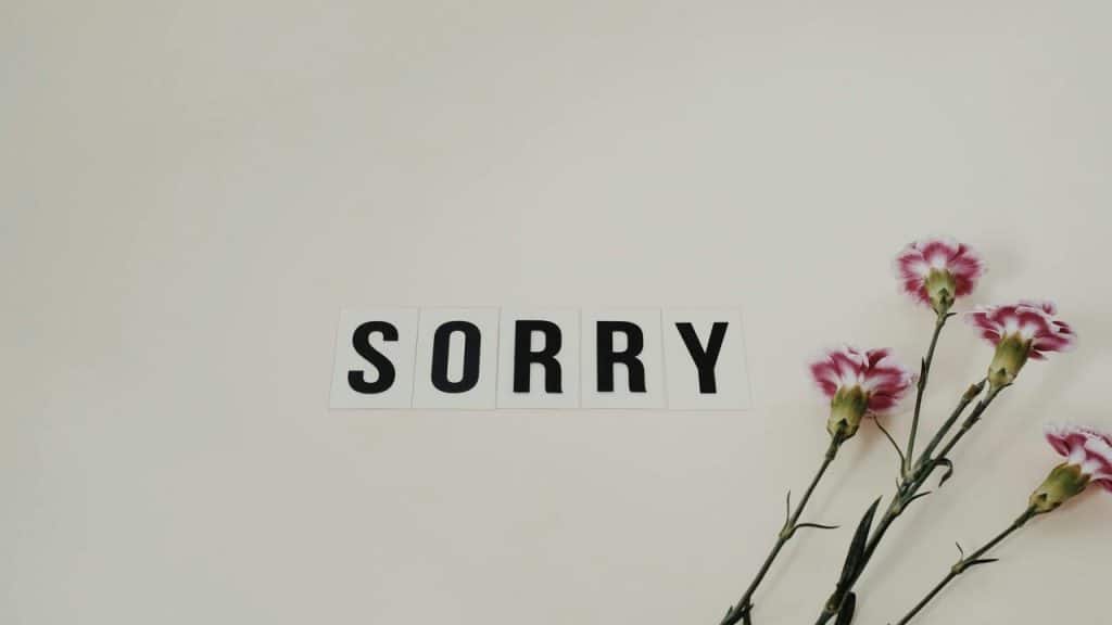 The word “sorry” beside flowers.