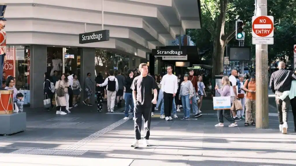 Man standing out in a crowd through quiet presence.