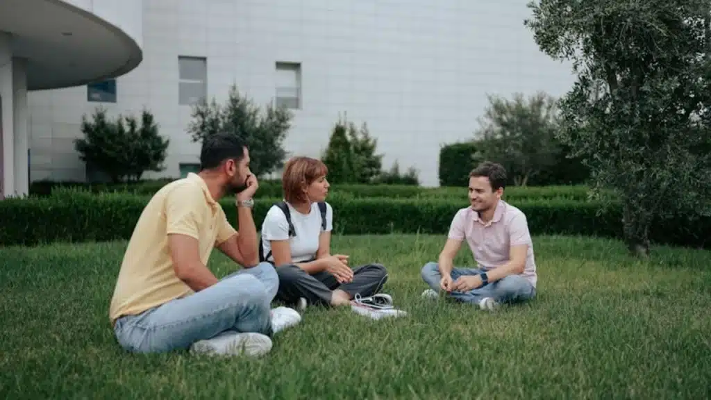 Man calmly anchoring a conversation in a group setting.