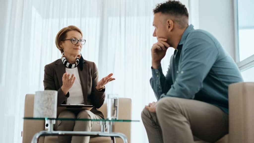 Man making eye contact and focusing on his partner while she speaks.
