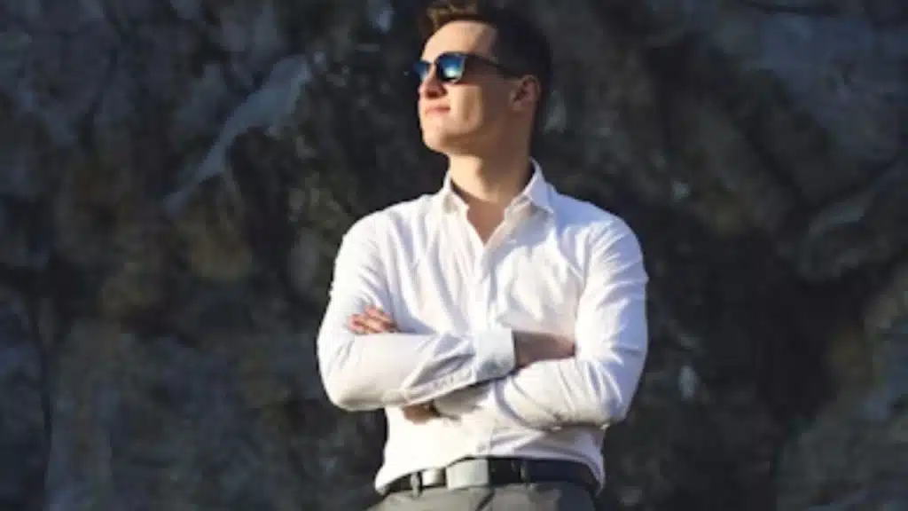 Confident man with calm demeanor in a relaxed environment.