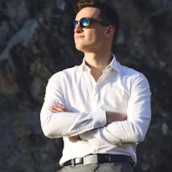 Confident man with calm demeanor in a relaxed environment.
