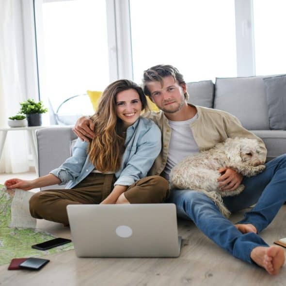 A young couple at home planning their vacation.