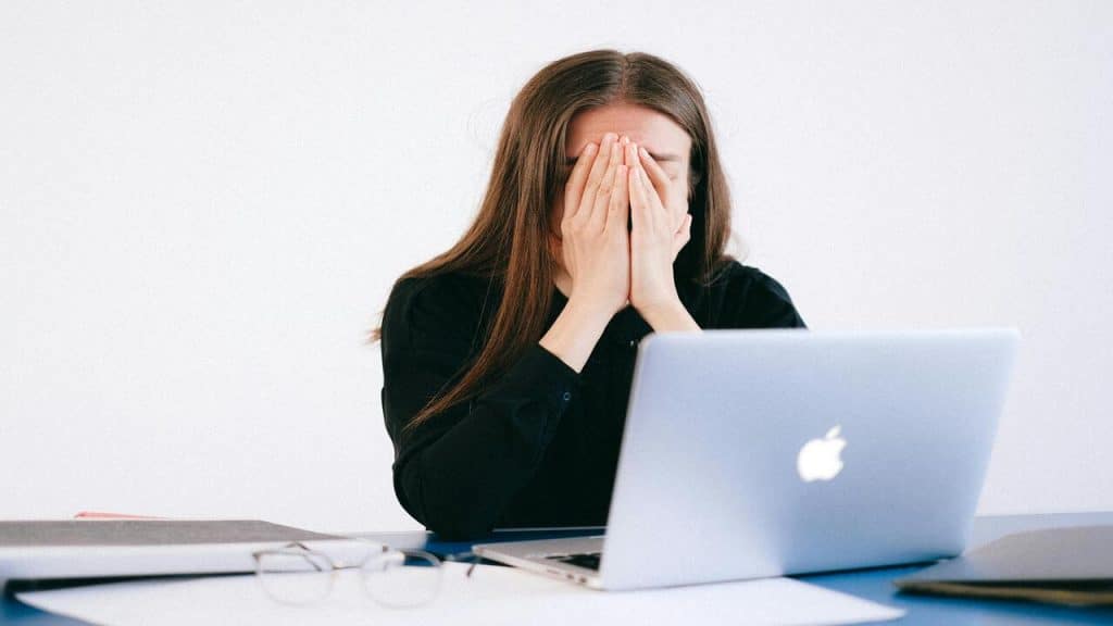 A woman looking frustrated at work.