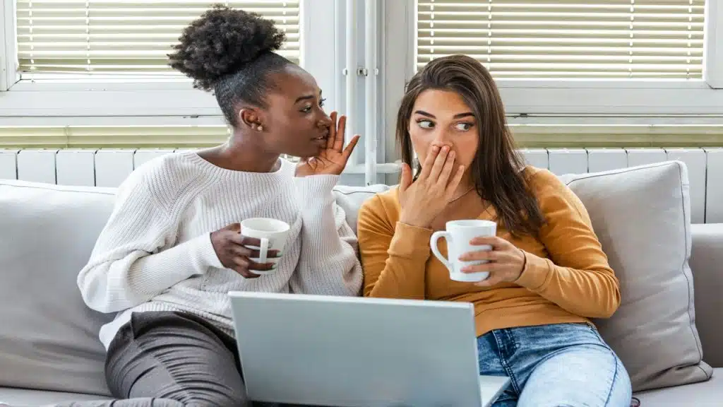 Two women gossiping at work.