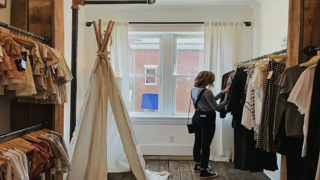 A woman selecting clothes at a store.