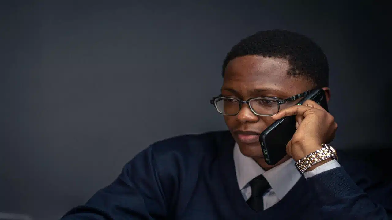 A man on the phone making plans.