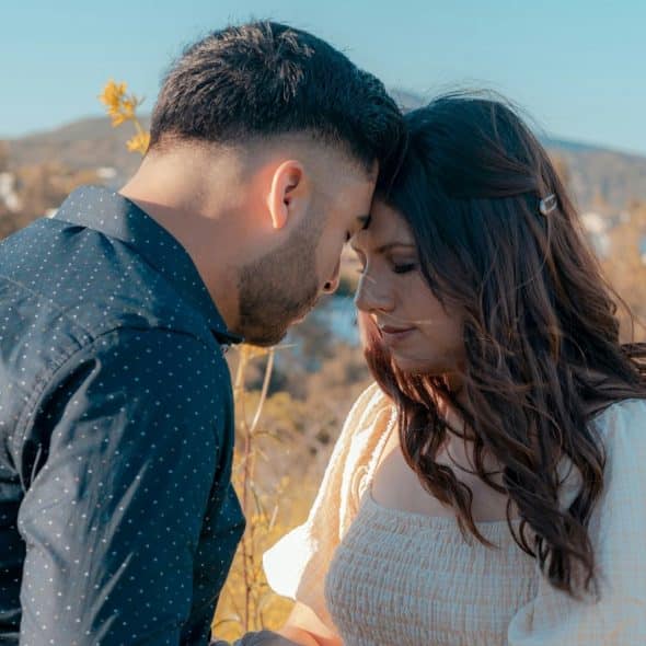 A man and woman being close together.