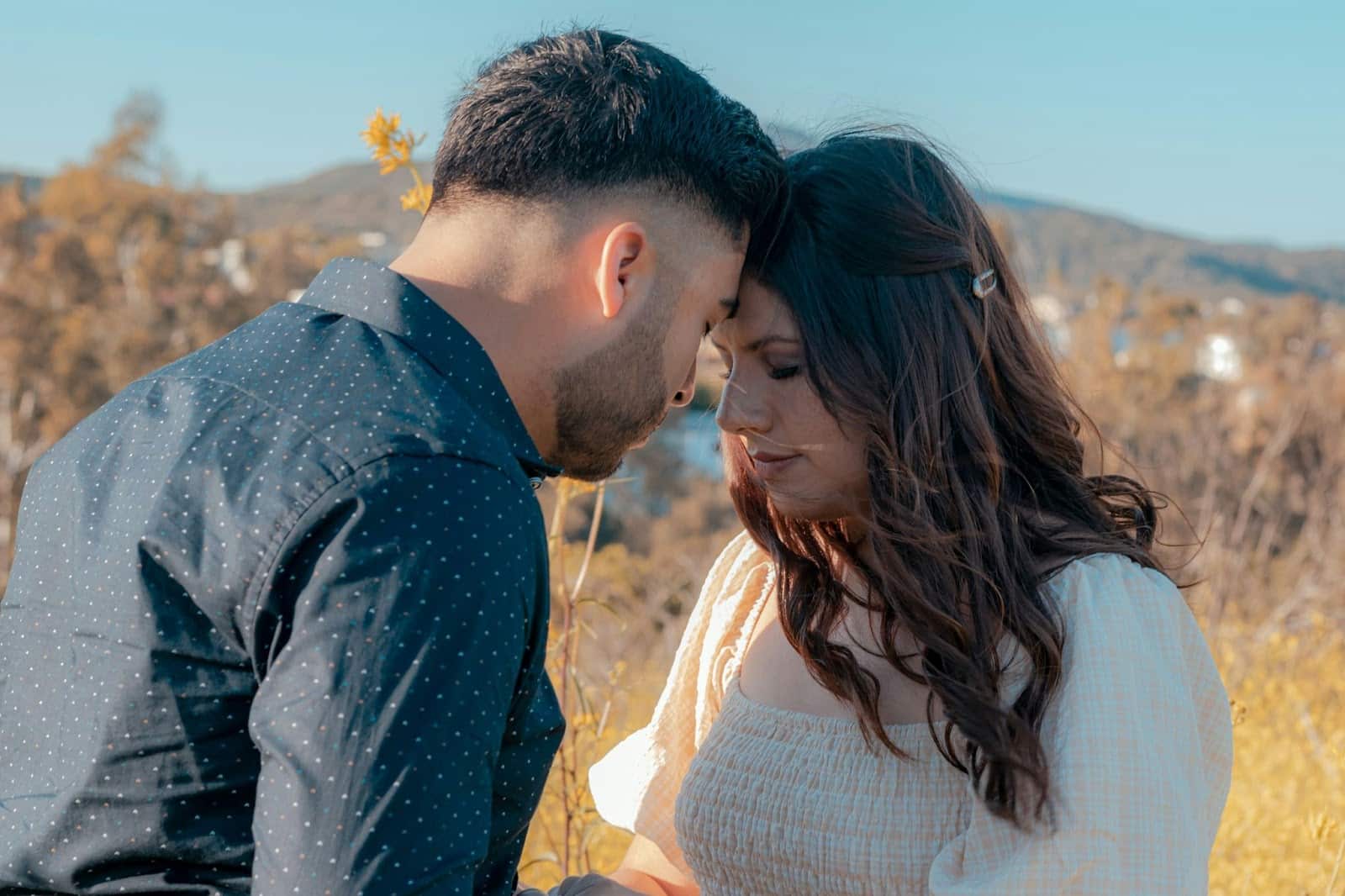 A man and woman being close together.