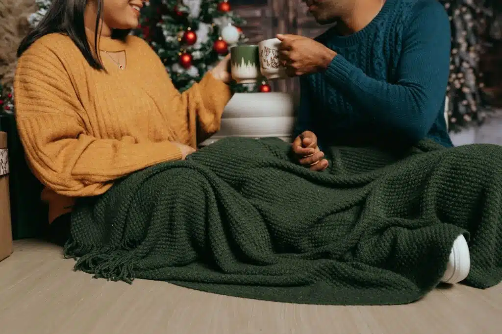 A man and woman under the blanket.