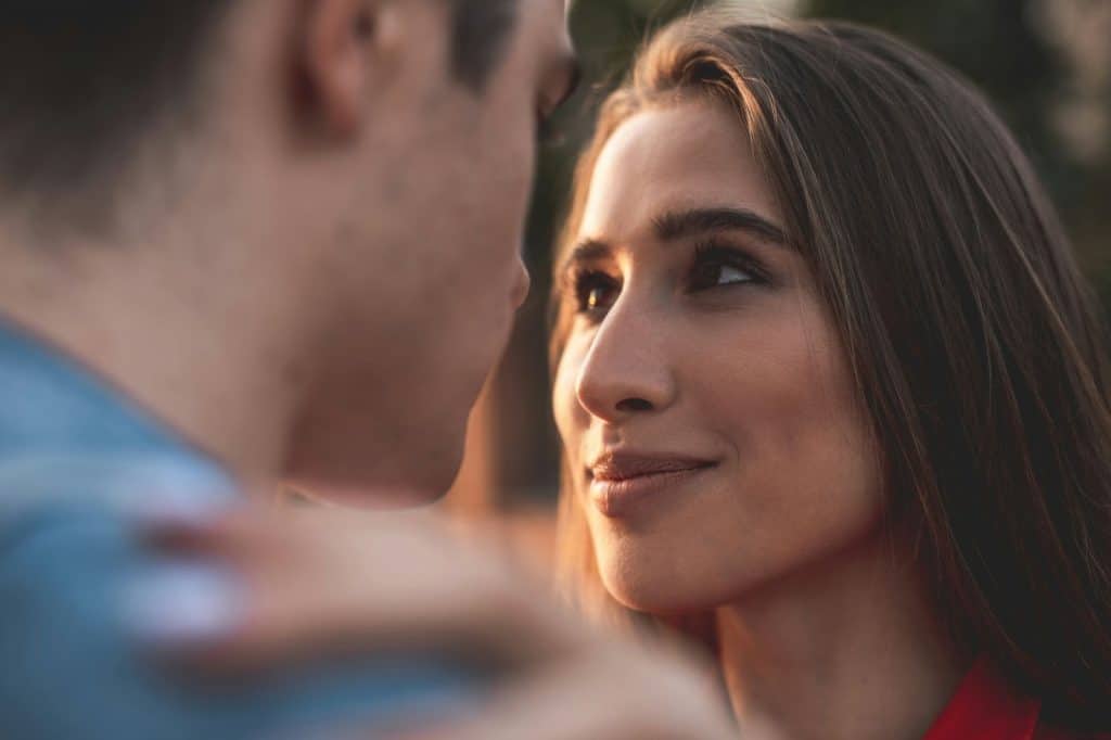A man and woman looking at each other.