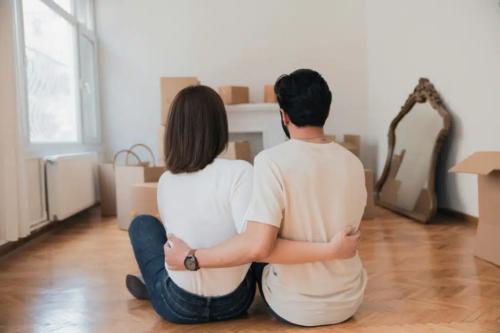 A man and woman sitting at the floor.