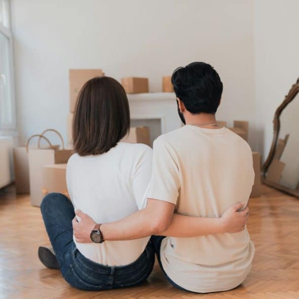 A man and woman sitting at the floor.