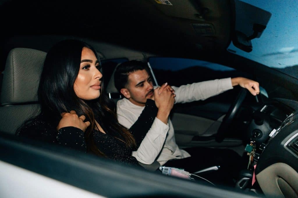 A man and woman inside the car.