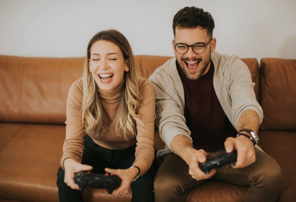 A man and woman playing a video games.