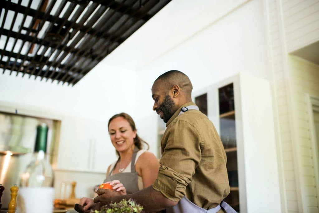 A man and woman cooking together.