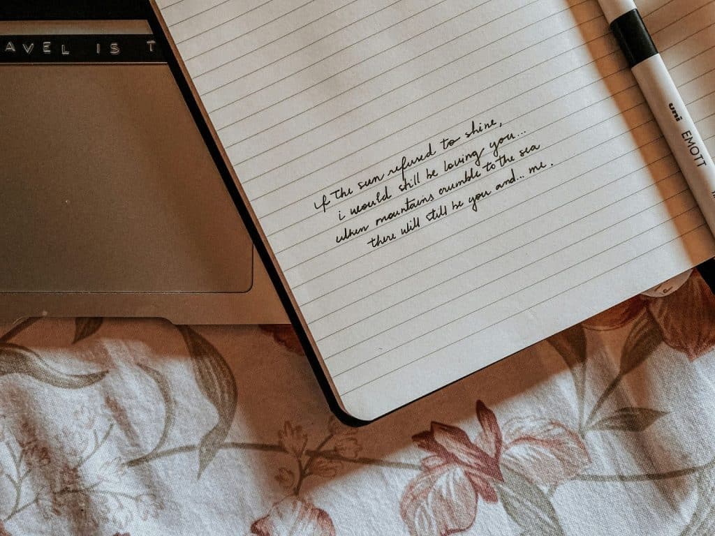 A note that is written on a notebook.