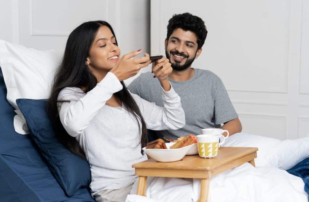 A woman taking a picture of a meal that her husband made.