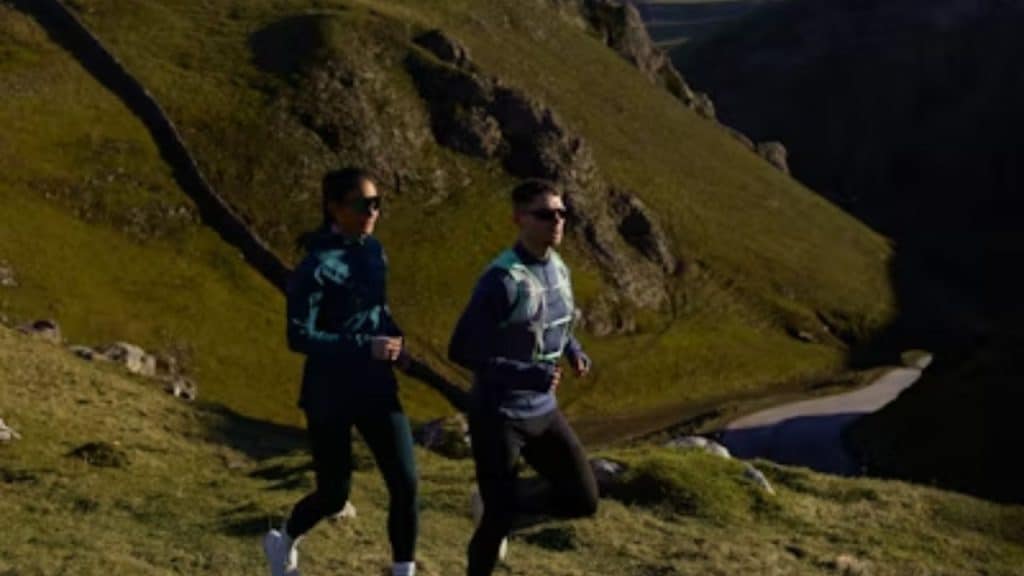Couple hiking uphill together.